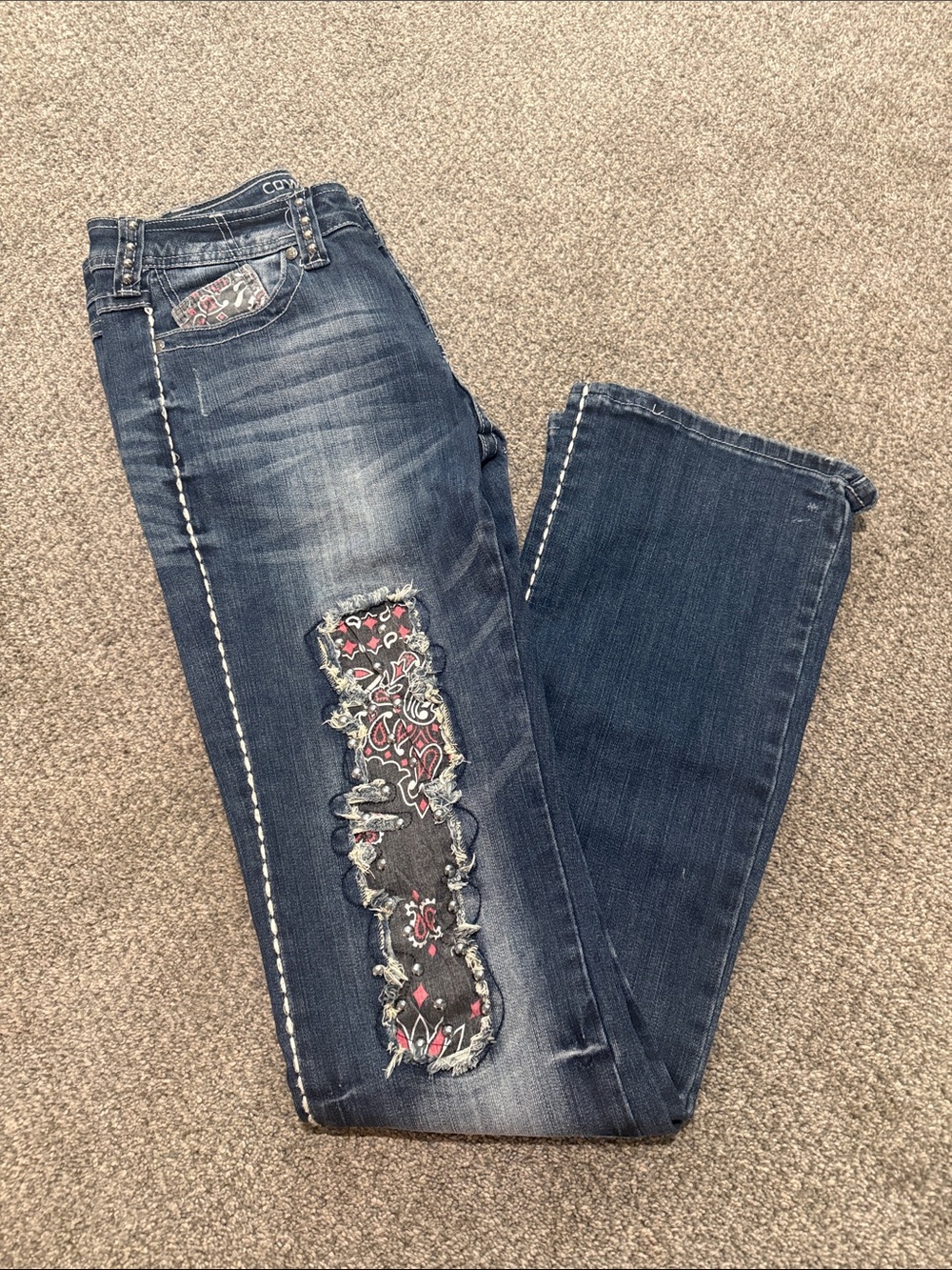 Cowgirl Tuff Distressed Dark Wash Women’s Jeans with Paisley Patch.